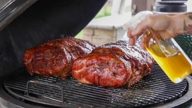 Raw pork butt on grill