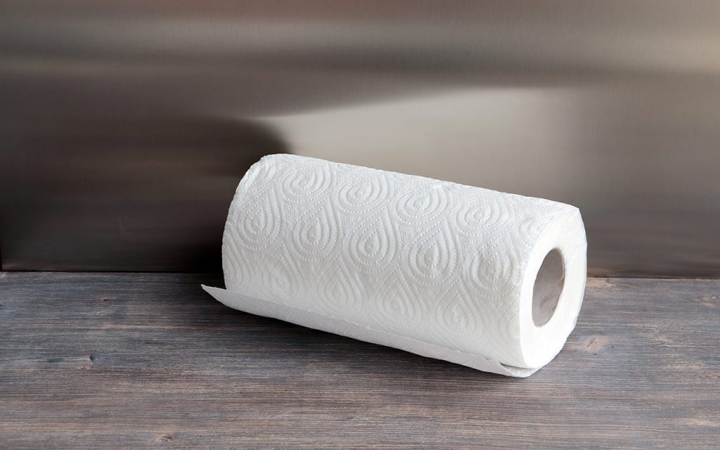 White kitchen paper towel on wooden table